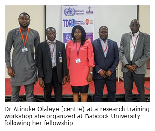 Image shows Dr Olaleye standing between four colleagues