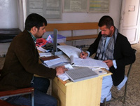 Two people at a desk seated opposite each other