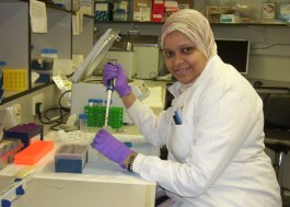 Photo shows Nahla seated at a lab desk