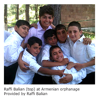 A photo of Raffi with children at an orphanage