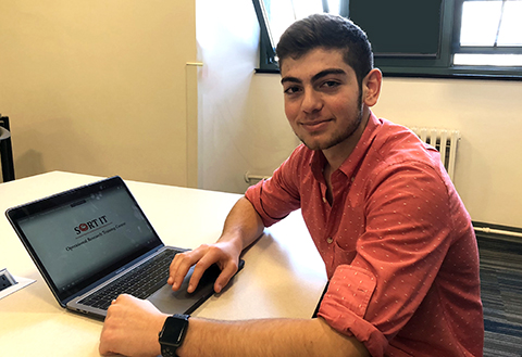 Raffi at his desk with laptop