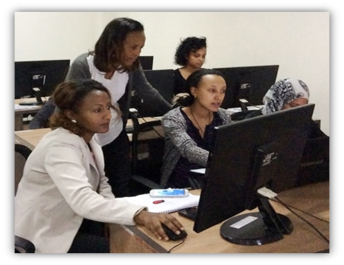 women looking at a computer monitor