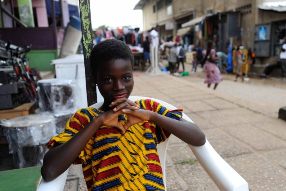 a young person sitting in a chair in marketplace