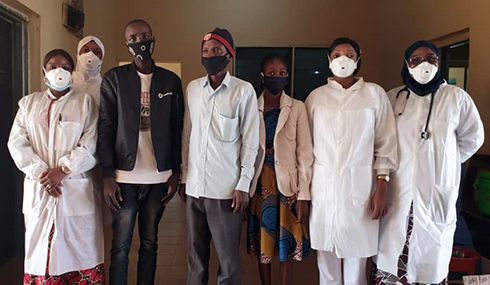 Image shows seven people wearing masks