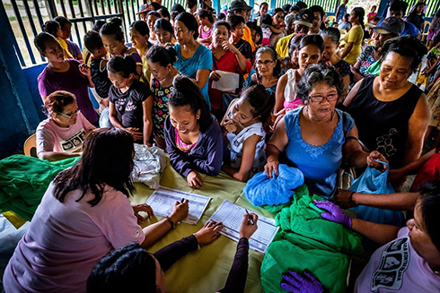 crowd of people collecting mosquito nets